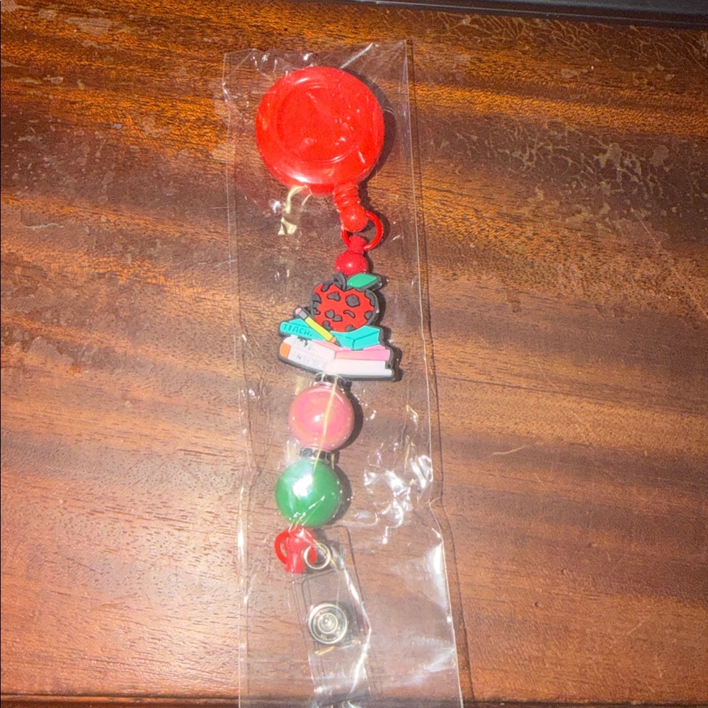 Colorful Badge Reel with Apple Stacked on Books Design